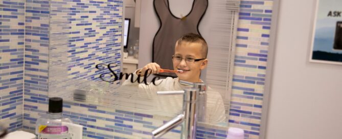 Your guide to orthodontics when you're sick 10 A boy brushing his teeth in a bathroom