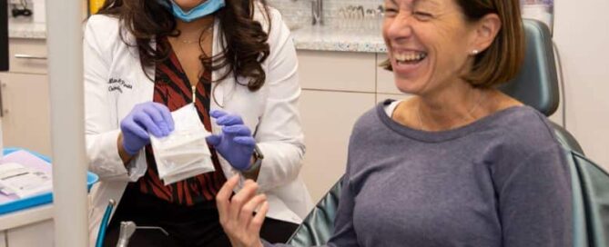 10 braces myths you need to know 12 A woman sitting in a chair laughing with dr. Parikh cropped