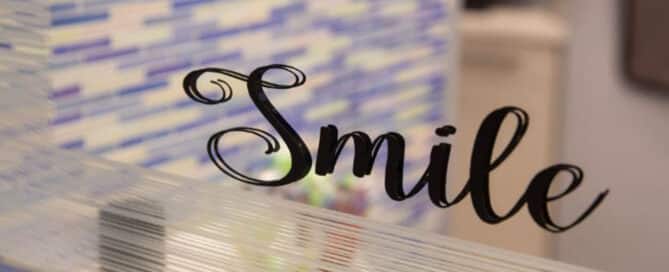 7 tips for brushing your teeth with braces 11 A close up of a mirror with a sticker that says smile