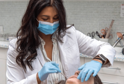 The hidden smiles orthodontic studio difference: life-changing smiles in melville, ny 7 Dr. Mita parikh working on a patient's teeth, representing hidden smiles orthodontic studio difference