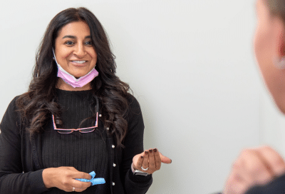 What to expect at your first orthodontist visit 6 Dr. Mita a. Parikh talking to a team member, representing what to expect at your first orthodontist visit