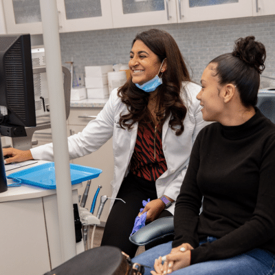 Who are candidates for lingual braces? 3 Dr. Mita a. Parikh meeting with a patient at hidden smiles orthodontic studio, representing candidates for lingual braces
